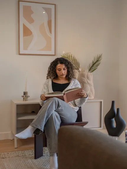 Person sitting and reading in living room
