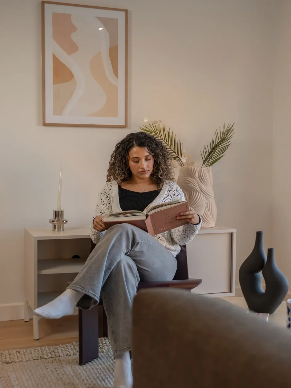 Person sitting and reading in living room